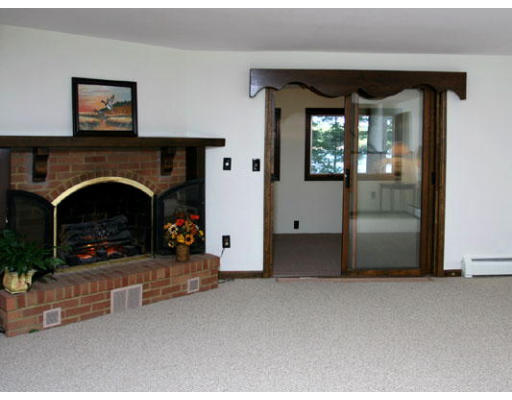12 Robinwood Road Littleton, MA 01460 - Photo 8 of 13 a living room with furniture and a fireplace