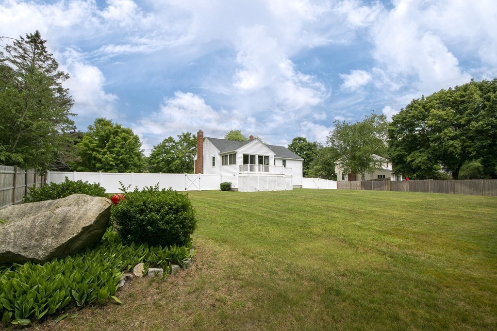 9 Heritage Road Hingham, MA 02043 - Photo 10 of 11 a view of a garden with plants and large trees