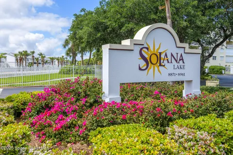 a sign that is in front of flowers