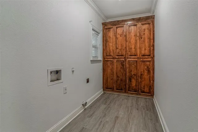 a view of a hallway with wooden floor and closet