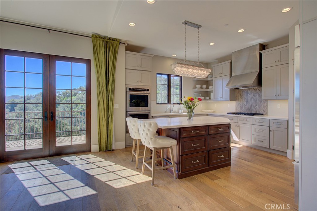 250 Mission Springs Road Arroyo Grande, CA 93420 - Photo 16 of 73 a kitchen with stainless steel appliances kitchen island granite countertop a table chairs sink and cabinets