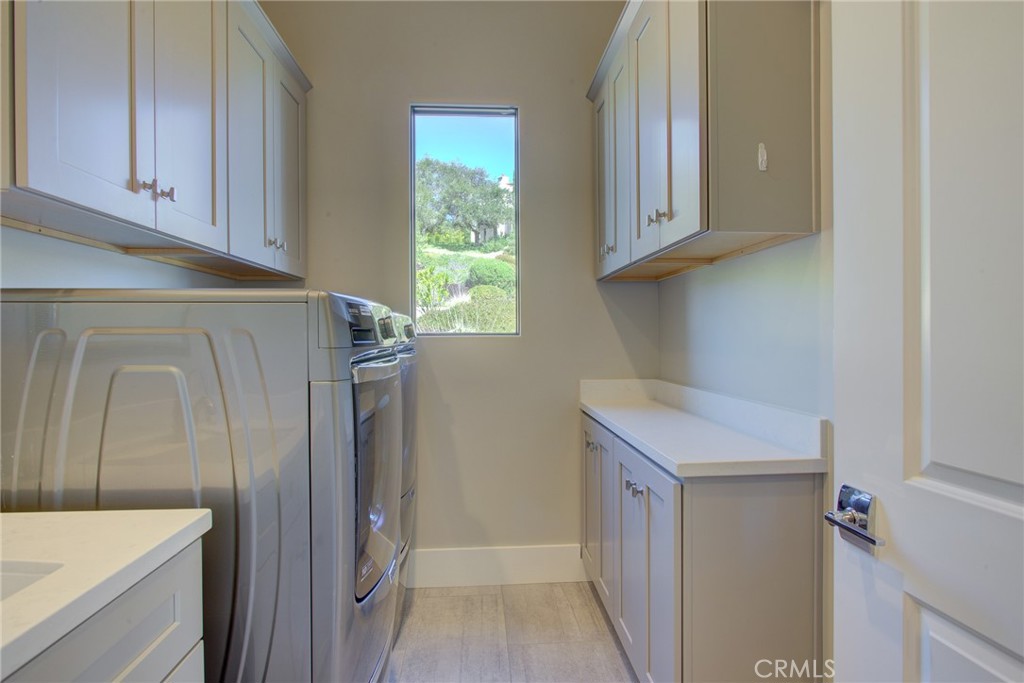 250 Mission Springs Road Arroyo Grande, CA 93420 - Photo 37 of 73 a utility room with cabinets washer and dryer