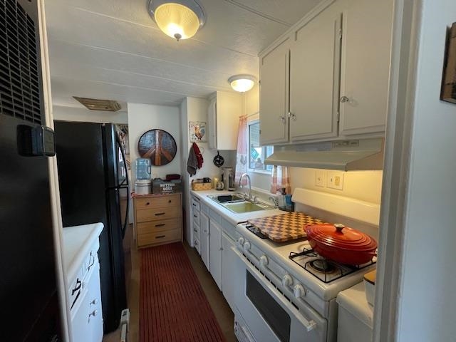 16629 Allison Way, Unit 22 Sonora, CA 95370 - Photo 11 of 31 Kitchen featuring white gas stove, a heating unit, light countertops, white cabinetry, and freestanding refrigerator