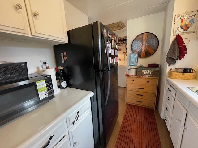 16629 Allison Way, Unit 22 Sonora, CA 95370 - Photo 12 of 31 Kitchen with white cabinetry, light countertops, stainless steel microwave, and freestanding refrigerator