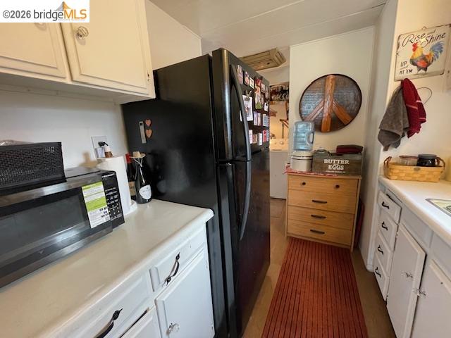 16629 Allison Way, Unit 22 Sonora, CA 95370 - Photo 12 of 30 Kitchen with white cabinetry, light countertops, stainless steel microwave, and freestanding refrigerator