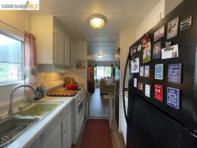 16629 Allison Way, Unit 22 Sonora, CA 95370 - Photo 13 of 30 a kitchen with stainless steel appliances granite countertop a stove refrigerator and a sink