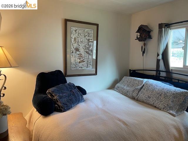 16629 Allison Way, Unit 22 Sonora, CA 95370 - Photo 15 of 30 a bedroom with a bed and a painting on the wall
