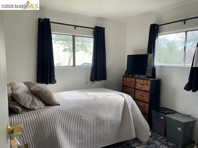 16629 Allison Way, Unit 22 Sonora, CA 95370 - Photo 19 of 30 a bedroom with a bed and a flat tv screen on a dresser
