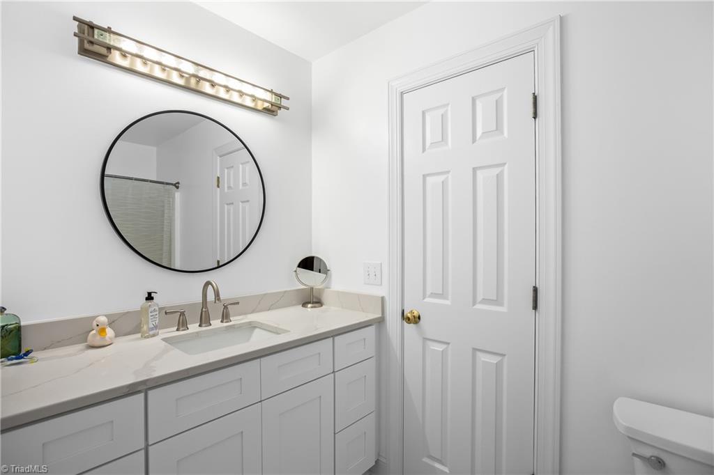 8703 Bromfield Road Oak Ridge, NC 27310 - Photo 23 of 34 Jack and Jill bathroom connected to bedroom two with the bay window.
