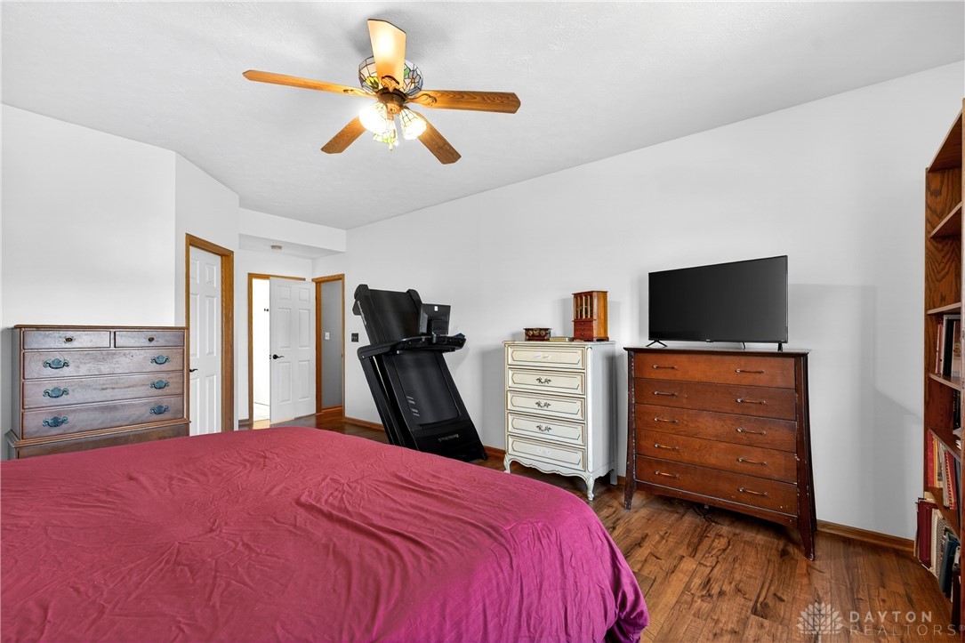 6560 Snyder Road Fletcher, OH 45326 - Photo 29 of 71 This spacious bedroom features classic hardwood flooring and a stylish ceiling fan for comfort.