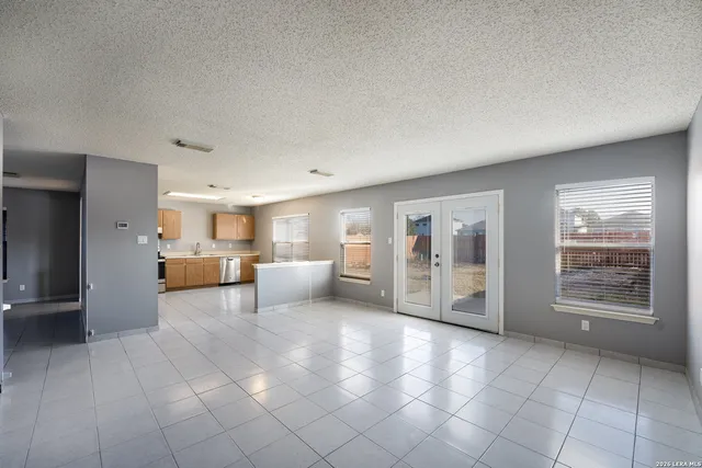 a view of a kitchen with furniture and an empty room