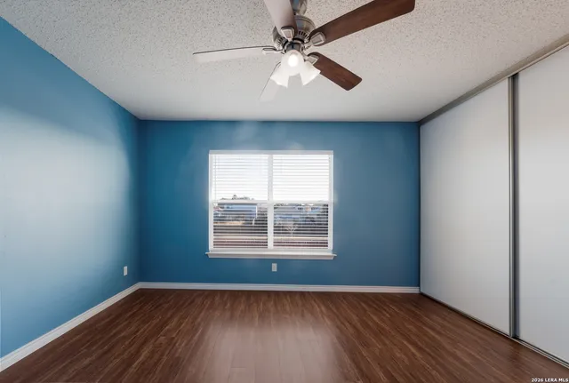 a view of a room with wooden floor and a window