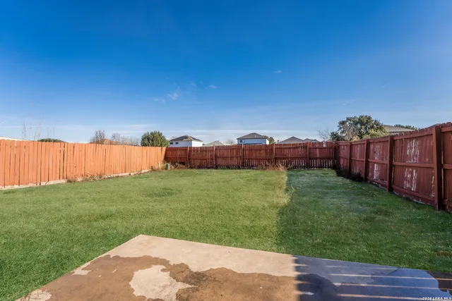 a view of a house with backyard and porch