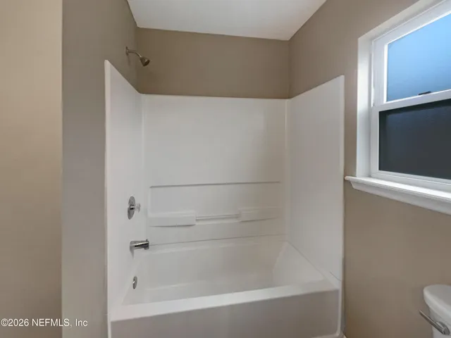 an empty room with a empty space and windows