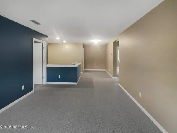 a view of an empty room with a window