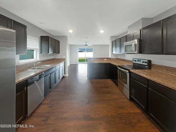 a large kitchen with stainless steel appliances lots of counter top space