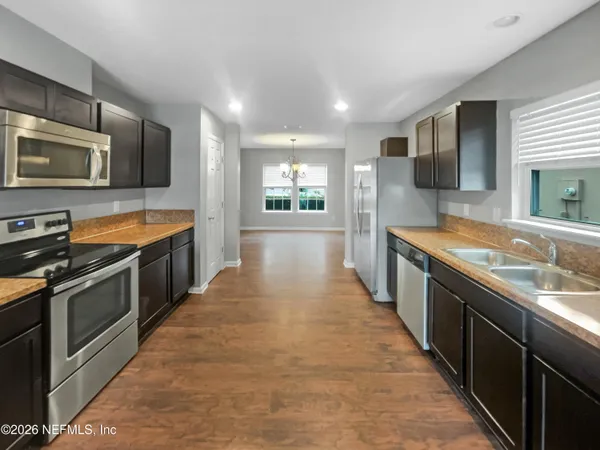a large kitchen with stainless steel appliances double cabinets and stainless steel appliances