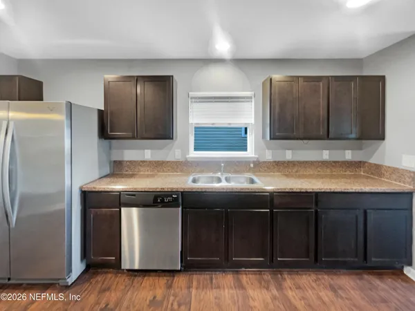 a kitchen with a sink and a refrigerator