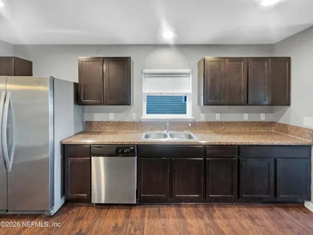 a kitchen with a sink and a refrigerator