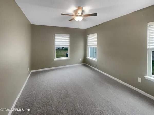 a view of a room with a window and a ceiling fan