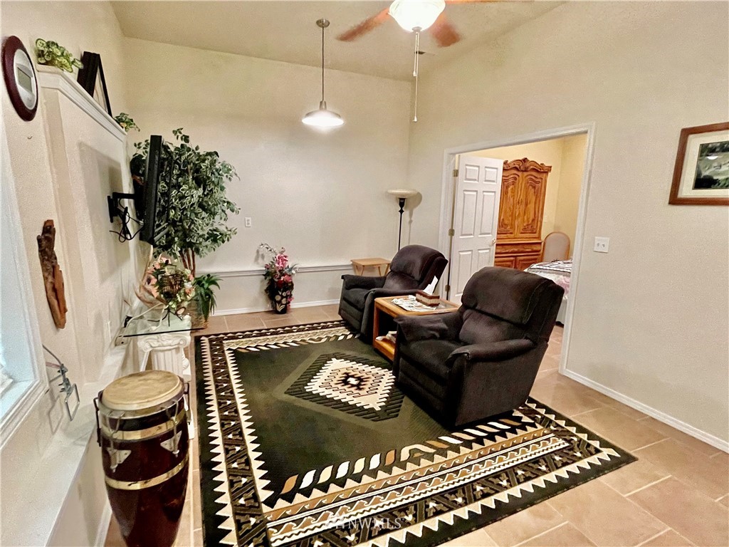 19225 Patterson Road East Orting, WA 98360 - Photo 15 of 34 a living room with furniture and a chandelier