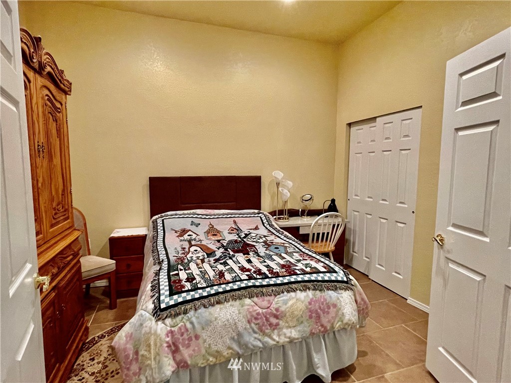 19225 Patterson Road East Orting, WA 98360 - Photo 22 of 34 a bedroom with a bed and wooden floor