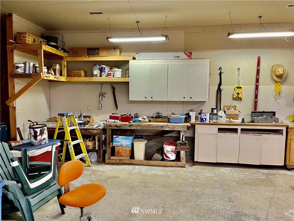 19225 Patterson Road East Orting, WA 98360 - Photo 26 of 34 a storage room with lots of clutter and cabinets
