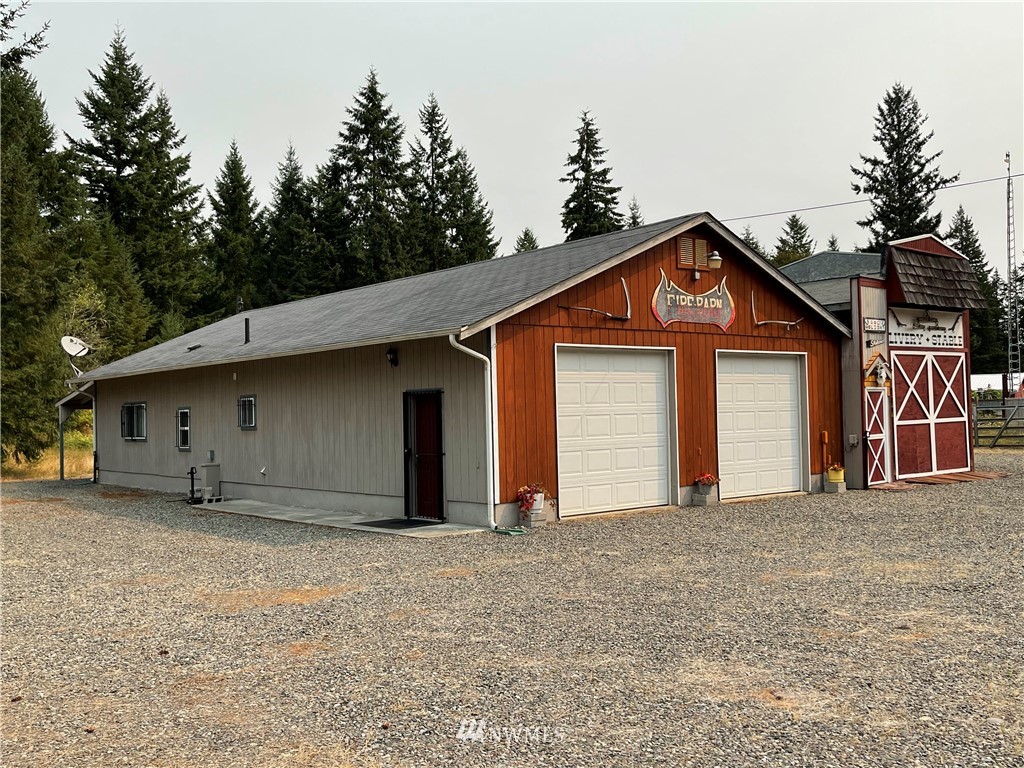 19225 Patterson Road East Orting, WA 98360 - Photo 5 of 34 a front view of a house with a yard