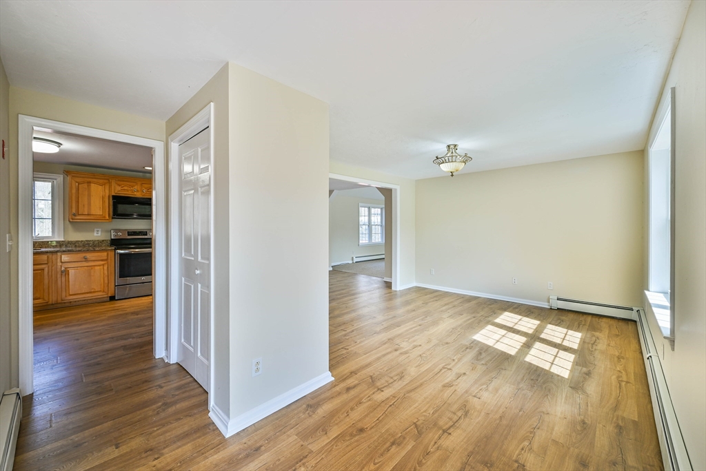 99 Smith Road Charlton, MA 01507 - Photo 11 of 37 a view of a hallway with wooden floor and a living room