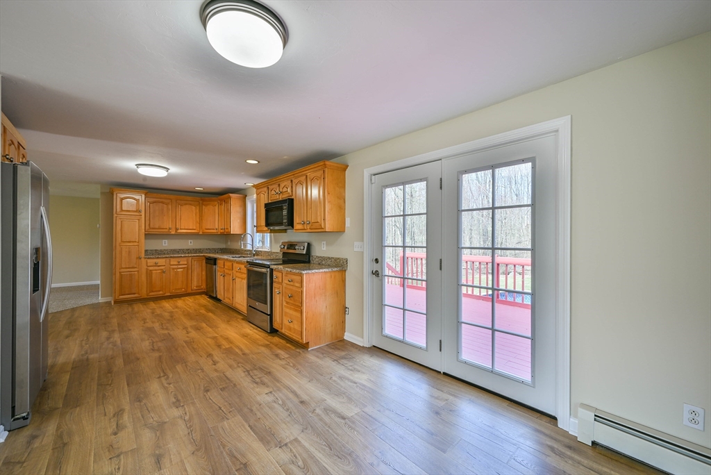 99 Smith Road Charlton, MA 01507 - Photo 14 of 37 a view of kitchen with wooden floor and window