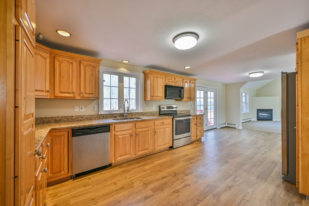 99 Smith Road Charlton, MA 01507 - Photo 18 of 37 a large kitchen with stainless steel appliances granite countertop a stove and a sink