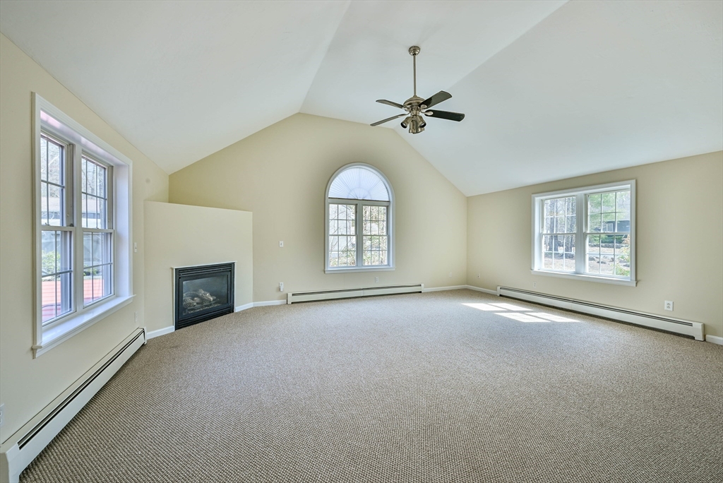 99 Smith Road Charlton, MA 01507 - Photo 20 of 37 a view of an empty room with a fireplace and a window