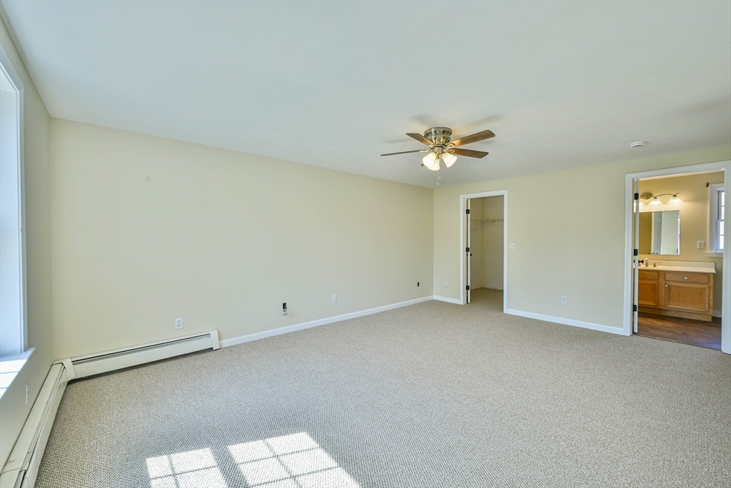 99 Smith Road Charlton, MA 01507 - Photo 31 of 37 an empty room with a ceiling fan and a window