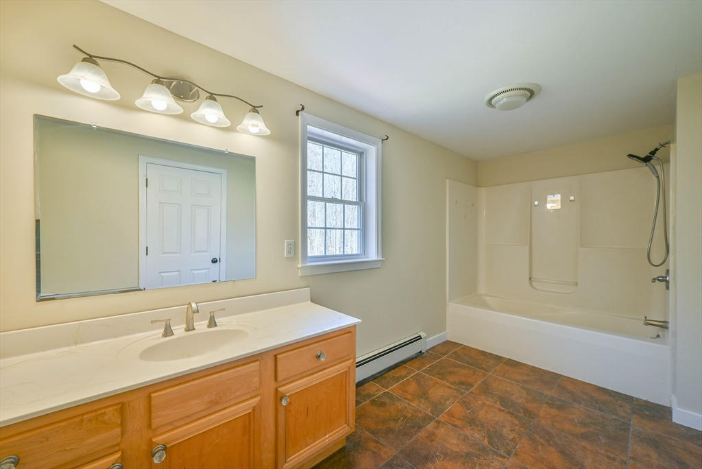 99 Smith Road Charlton, MA 01507 - Photo 32 of 37 a bathroom with a sink mirror and a shower