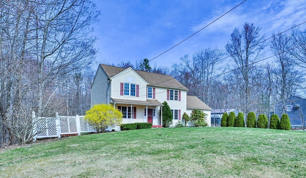 99 Smith Road Charlton, MA 01507 - Photo 4 of 37 a view of a house with a big yard and large trees