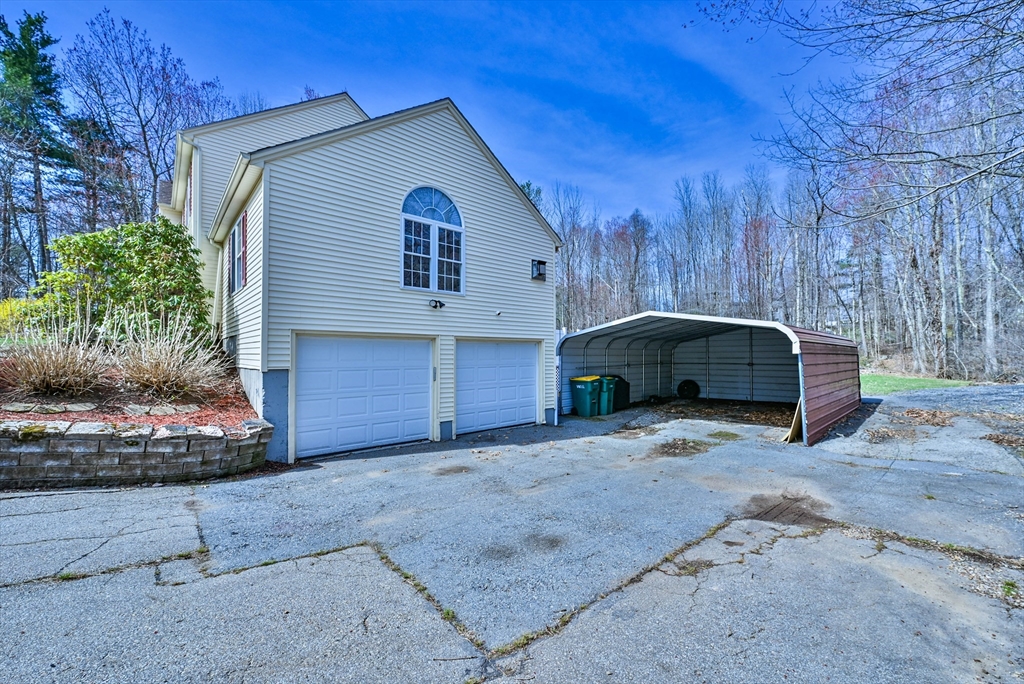 99 Smith Road Charlton, MA 01507 - Photo 6 of 37 a view of a house with a backyard and bushes