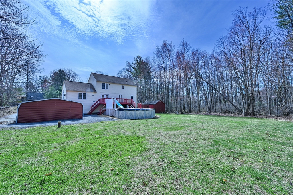 99 Smith Road Charlton, MA 01507 - Photo 8 of 37 a backyard of a house with table and chairs