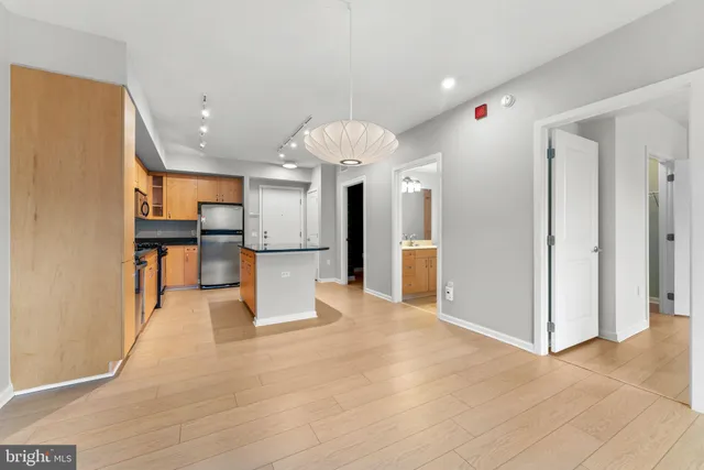 a view of a kitchen with furniture and a refrigerator