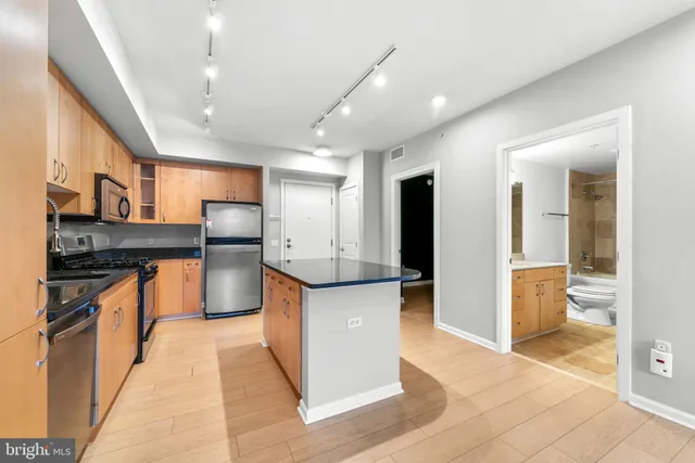 a large kitchen with stainless steel appliances lots of counter top space and cabinets