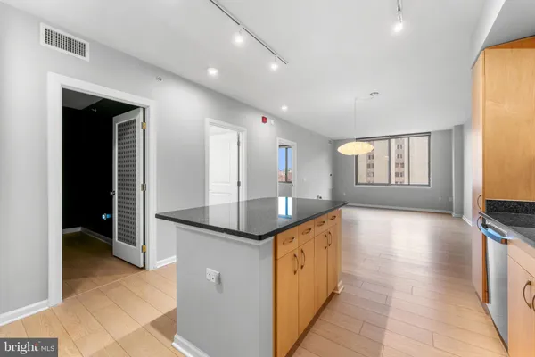 a kitchen with granite countertop a sink and a stove top oven