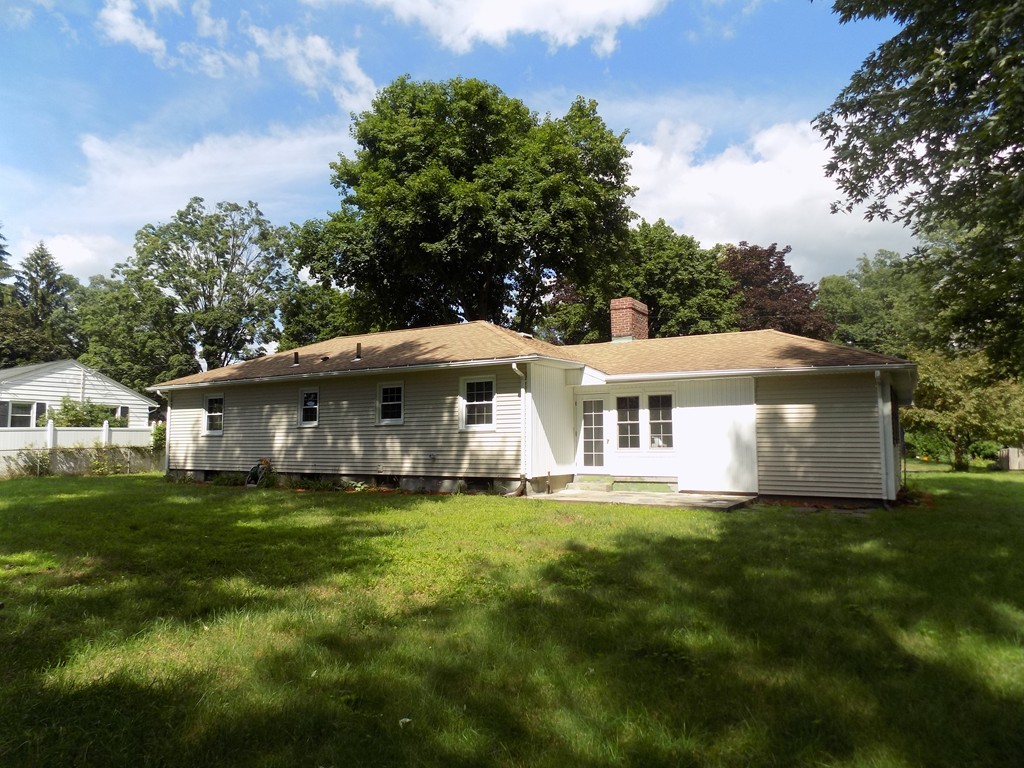 90 Embassy Road Springfield, MA 01119 - Photo 17 of 18 a white house in middle of the green field