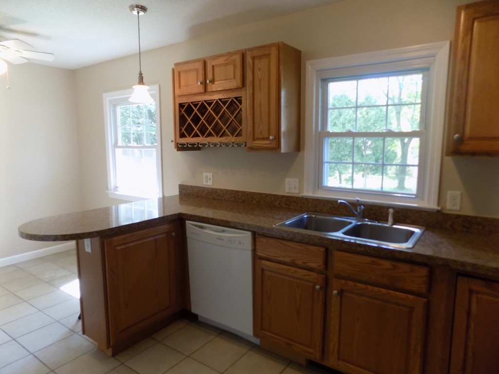 90 Embassy Road Springfield, MA 01119 - Photo 3 of 18 a kitchen with granite countertop a sink and a window