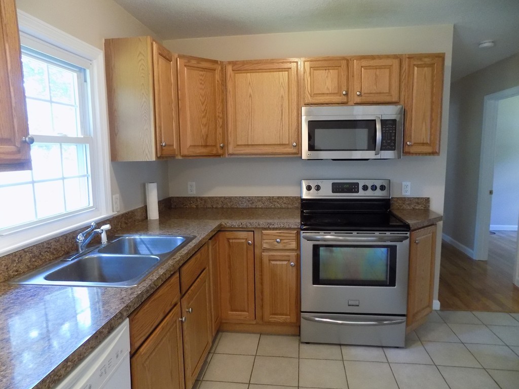 90 Embassy Road Springfield, MA 01119 - Photo 4 of 18 a kitchen with stainless steel appliances granite countertop a sink stove and microwave