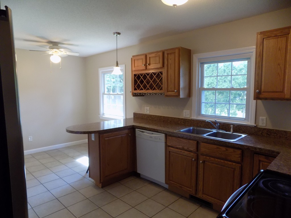 90 Embassy Road Springfield, MA 01119 - Photo 5 of 18 a kitchen with a sink window and cabinets