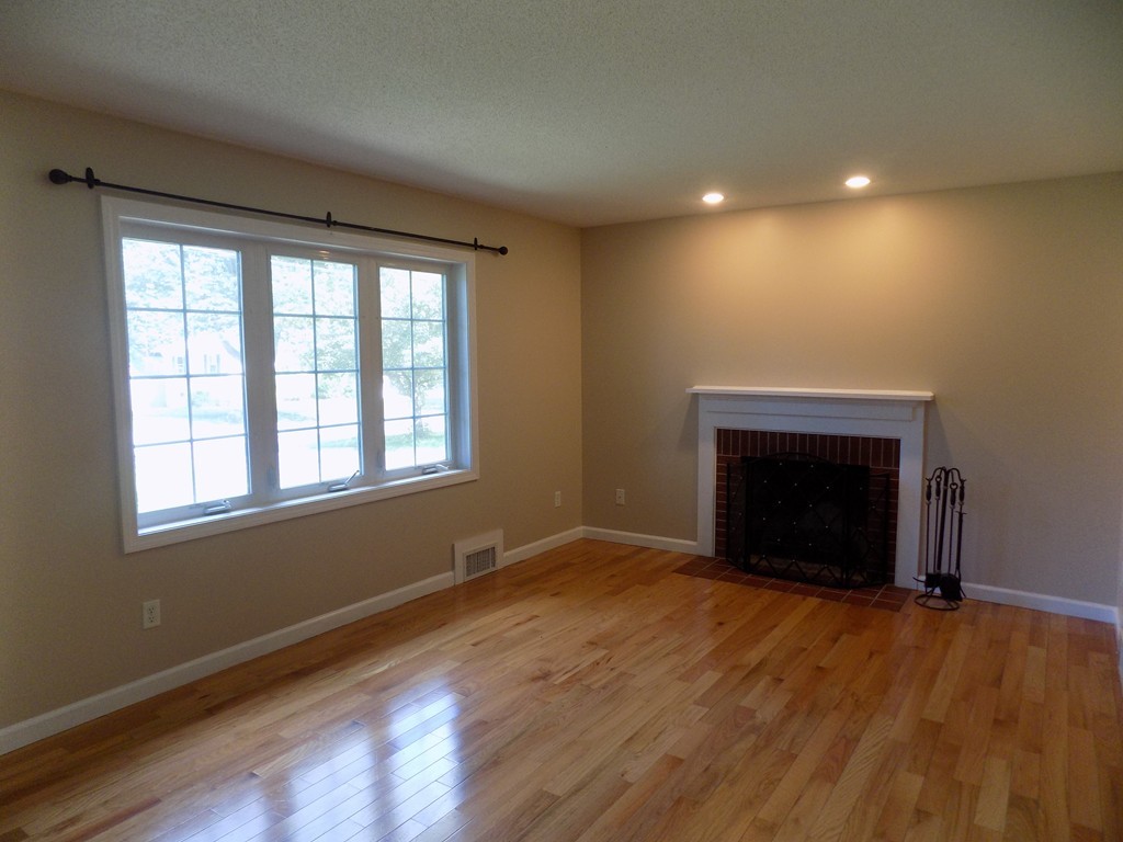 90 Embassy Road Springfield, MA 01119 - Photo 6 of 18 a view of an empty room with wooden floor and a window