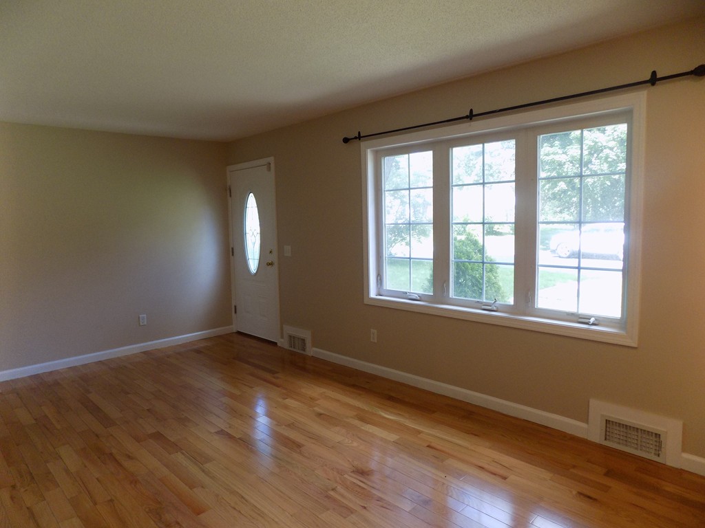 90 Embassy Road Springfield, MA 01119 - Photo 7 of 18 a view of an empty room with wooden floor and a window