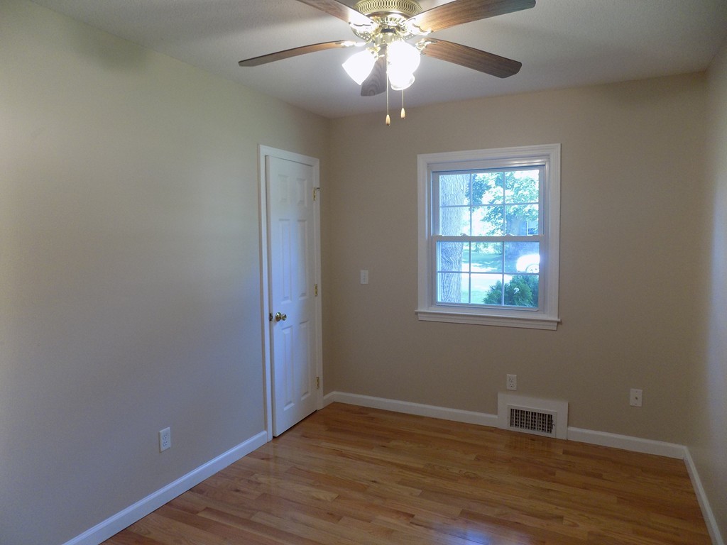 90 Embassy Road Springfield, MA 01119 - Photo 9 of 18 a view of an empty room with wooden floor and a window