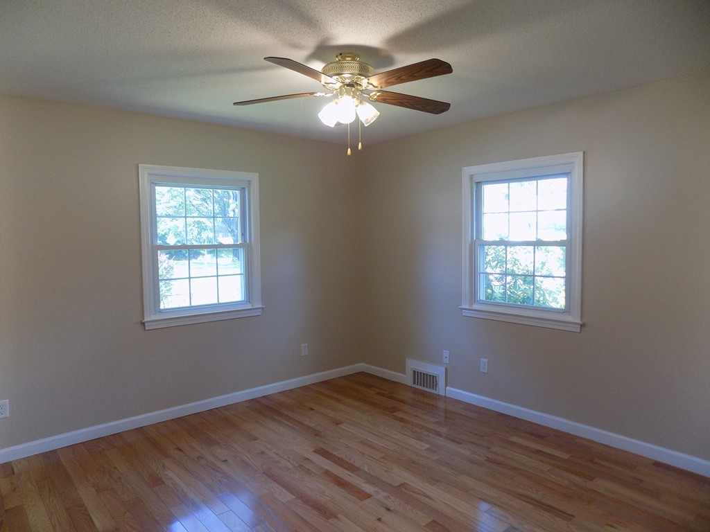 90 Embassy Road Springfield, MA 01119 - Photo 10 of 18 a view of an empty room with wooden floor and a window