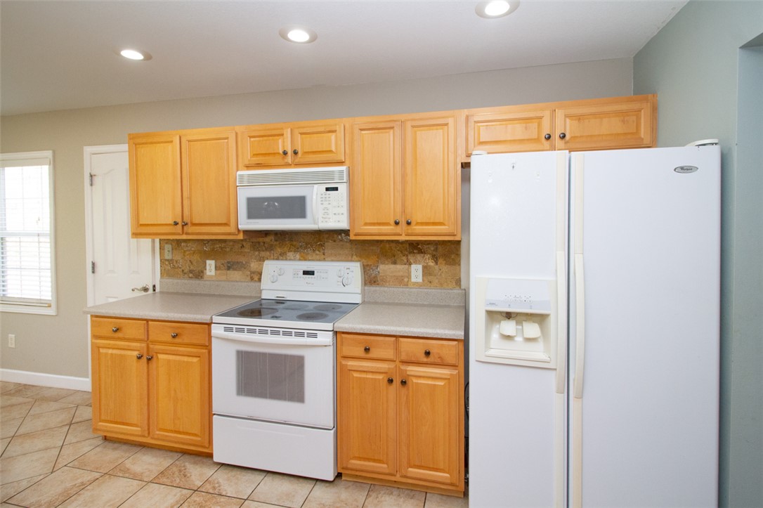 735 Britton Street Anderson, SC 29621 - Photo 21 of 50 This bright kitchen features ample cabinetry and modern appliances, creating a functional cooking space.