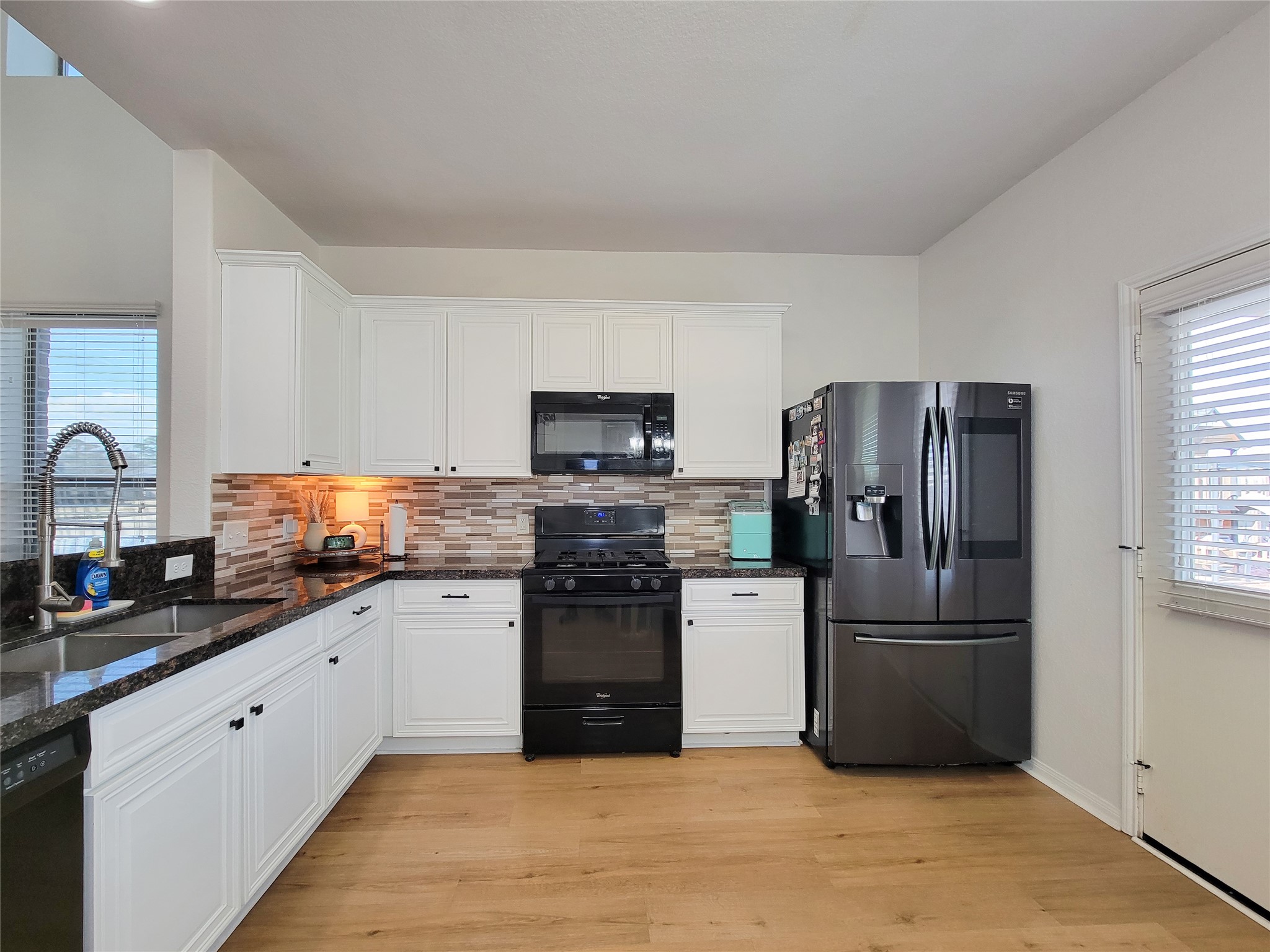 108 Sam Drive Dayton, TX 77535 - Photo 11 of 38 a kitchen with granite countertop a refrigerator sink and stove